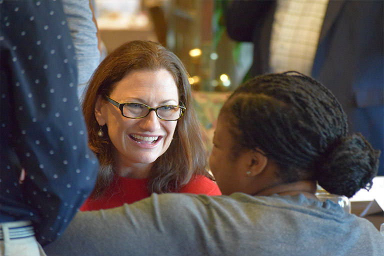 Two women chat at the John Whittenberger Society's annual luncheon. 